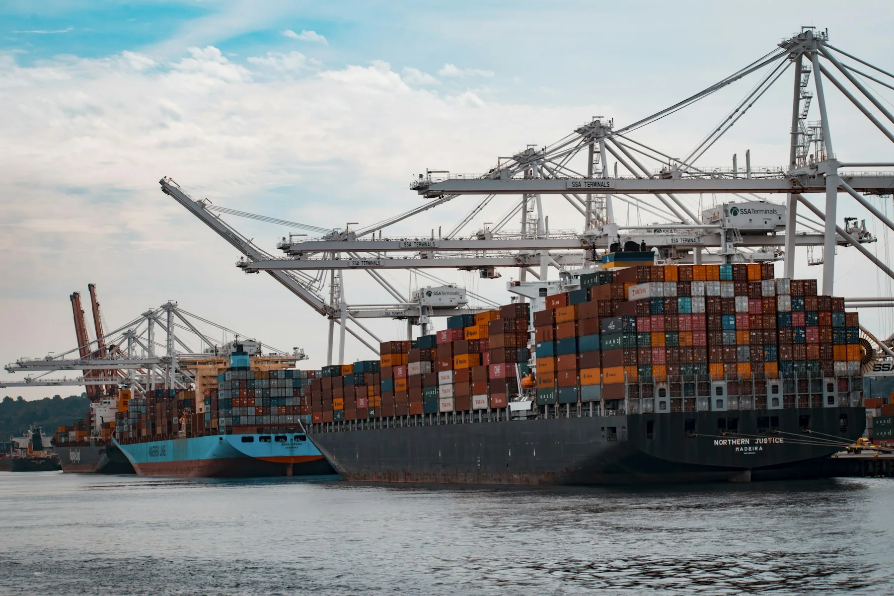 Commercial vessels alongside a busy international port